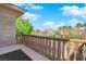 Balcony overlooking neighboring houses and mature trees on a sunny day at 807 Canyon Greens Dr, Las Vegas, NV 89144