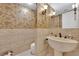 Elegant powder room featuring unique textured walls and a sophisticated pedestal sink at 807 Canyon Greens Dr, Las Vegas, NV 89144