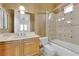 Well lit bathroom with vanity, floral wallpaper and shower-tub combo at 807 Canyon Greens Dr, Las Vegas, NV 89144