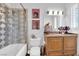 Charming bathroom offering vanity, tiled shower over tub and natural light at 807 Canyon Greens Dr, Las Vegas, NV 89144