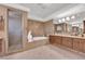 Elegant bathroom featuring marble walls, double sink vanity, soaking tub, and glass shower at 807 Canyon Greens Dr, Las Vegas, NV 89144