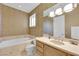 Bright bathroom with a soaking tub and a large vanity with neutral color palette at 807 Canyon Greens Dr, Las Vegas, NV 89144