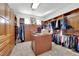 Spacious walk-in closet with custom wood shelving, drawers, and a central island for organization at 807 Canyon Greens Dr, Las Vegas, NV 89144