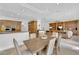 Open-concept dining area featuring a wood table and chairs, seamlessly connecting to the kitchen and living spaces at 807 Canyon Greens Dr, Las Vegas, NV 89144