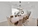 Dining room with modern chandelier and table, with open access to foyer and fireplace at 807 Canyon Greens Dr, Las Vegas, NV 89144