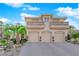Impressive three-car garage home featuring beautiful balconies, stone accents, and manicured landscaping at 807 Canyon Greens Dr, Las Vegas, NV 89144