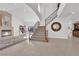 Spacious living room boasts a fireplace, staircase, and access to other rooms in home at 807 Canyon Greens Dr, Las Vegas, NV 89144