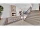 Inviting living room features a fireplace, an elegant area rug, and staircase access at 807 Canyon Greens Dr, Las Vegas, NV 89144
