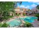 Spacious backyard boasting pool, spa, and lush landscaping at 807 Canyon Greens Dr, Las Vegas, NV 89144