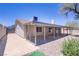 Backyard featuring a covered patio, desert landscaping and mature trees at 823 Cherry Dr, Henderson, NV 89002