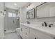 Modern bathroom featuring a double vanity, sleek fixtures, and a glass-enclosed shower at 823 Cherry Dr, Henderson, NV 89002