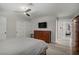 Spacious bedroom boasts wood-look flooring, closet, and dresser under mounted TV at 823 Cherry Dr, Henderson, NV 89002