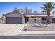 Charming single-story home featuring desert landscaping, a two-car garage, and solar panels at 823 Cherry Dr, Henderson, NV 89002