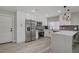 Modern kitchen features stainless steel appliances, white cabinetry, and a sleek waterfall countertop at 823 Cherry Dr, Henderson, NV 89002