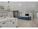 Bright, open living space with a kitchen view, fireplace, modern lighting, and seamless design at 823 Cherry Dr, Henderson, NV 89002