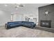 Spacious living room with a brick fireplace, modern lighting, and an open floor plan at 823 Cherry Dr, Henderson, NV 89002