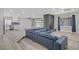 Open-concept living room with a brick fireplace, modern flooring, and a comfortable blue sectional at 823 Cherry Dr, Henderson, NV 89002