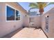 Private outdoor patio area with tiled flooring, stucco walls, and a view of the neighbor's RV at 823 Cherry Dr, Henderson, NV 89002