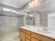 Bright bathroom featuring double sinks, a large mirror, and a modern glass-enclosed shower at 8739 Cerrito Canyon Ct, Las Vegas, NV 89148