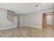 Spacious living room with wood-look flooring, white trim, and a staircase at 8739 Cerrito Canyon Ct, Las Vegas, NV 89148