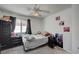 Neutral bedroom with ceiling fan, light walls and grey carpet has a window bringing in natural light at 8801 Duncan Barrel Ave # 103, Las Vegas, NV 89178