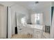 Bright dining room with chandelier, large mirror, and white dining set at 8801 Duncan Barrel Ave # 103, Las Vegas, NV 89178