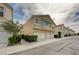 Attractive townhome exterior with a two-car garage, manicured landscaping, and a well-maintained facade at 8801 Duncan Barrel Ave # 103, Las Vegas, NV 89178