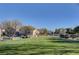 Neighborhood lawn with grass, trees and landscaping in front of single Gathering homes at 8801 Duncan Barrel Ave # 103, Las Vegas, NV 89178