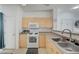 Functional kitchen with light wood cabinets and gas range oven at 8801 Duncan Barrel Ave # 103, Las Vegas, NV 89178