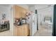 Kitchenette with cabinets and a white refrigerator adjacent to the dining room at 8801 Duncan Barrel Ave # 103, Las Vegas, NV 89178