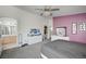 Cozy main bedroom featuring plush grey carpet, ceiling fan, and an ensuite bath and walk-in closet at 8801 Duncan Barrel Ave # 103, Las Vegas, NV 89178