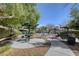 Community playground featuring benches and shady trees on a sunny day at 8801 Duncan Barrel Ave # 103, Las Vegas, NV 89178