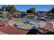 Playground equipment with bench seating is set on a colorful rubber base at 8801 Duncan Barrel Ave # 103, Las Vegas, NV 89178