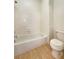 Bright bathroom featuring a bathtub and tiled shower with a standard toilet at 9319 Bronze River Ave, Las Vegas, NV 89149
