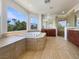 Luxurious bathroom with a soaking tub, a separate shower, and tile flooring at 9319 Bronze River Ave, Las Vegas, NV 89149