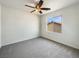 Bedroom featuring neutral carpet, a window, and a ceiling fan with light at 9319 Bronze River Ave, Las Vegas, NV 89149
