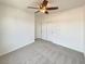 Bedroom with neutral carpet, ceiling fan, and closet at 9319 Bronze River Ave, Las Vegas, NV 89149