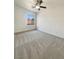 Bedroom featuring neutral carpet, a window, and ceiling fan with lighting at 9319 Bronze River Ave, Las Vegas, NV 89149
