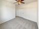 Bedroom with neutral carpet, ceiling fan, and closet with doors at 9319 Bronze River Ave, Las Vegas, NV 89149