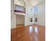 Bright, open floor plan features a soaring ceiling, hardwood floors, and an open staircase at 9319 Bronze River Ave, Las Vegas, NV 89149