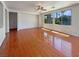 Spacious living room with hardwood floors, ceiling fan, and natural light at 9319 Bronze River Ave, Las Vegas, NV 89149