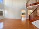 Spacious living room with hardwood floors and a staircase featuring wood railing at 9319 Bronze River Ave, Las Vegas, NV 89149