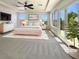 Bright main bedroom with plush carpet, balcony access, and ample natural light from large windows at 9319 Bronze River Ave, Las Vegas, NV 89149