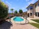 Backyard pool featuring a -proof fence, hardscape, and well-manicured turf at 9319 Bronze River Ave, Las Vegas, NV 89149