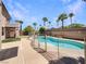 Backyard swimming pool, with metal fence and palm trees in a private yard at 9319 Bronze River Ave, Las Vegas, NV 89149