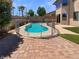 Backyard pool area with secure fencing, pavers, and artificial turf at 9319 Bronze River Ave, Las Vegas, NV 89149