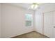 A carpeted bedroom with a ceiling fan, window and closet with sliding doors at 9629 Toy Soldier St, Las Vegas, NV 89178