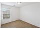 This empty bedroom includes neutral carpet, a window with blinds, and white walls at 9629 Toy Soldier St, Las Vegas, NV 89178