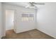 A bedroom with a window, carpet, ceiling fan, and white walls at 9629 Toy Soldier St, Las Vegas, NV 89178