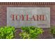 Neighborhood's sign, 'Toyland', a well-maintained community with lush greenery, signaling a welcoming environment at 9629 Toy Soldier St, Las Vegas, NV 89178